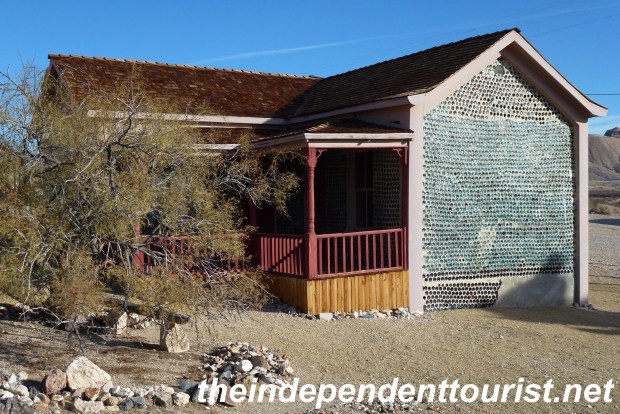 Tom Kelly's 3 room bottle house - built by Tom Kelly in 1906, to raffle it off. Use of sustainable materials would make the house popular today!