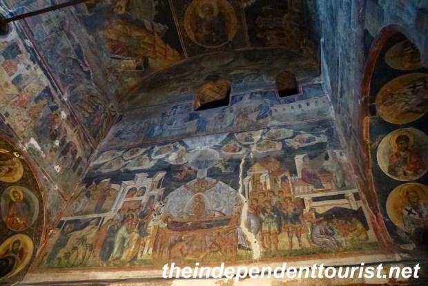 The frescoed wall above the church entrance.