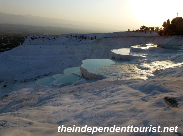 The setting sun reflecting on the travertine pools.