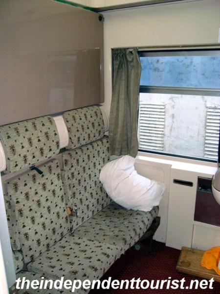 Interior of a train sleeper cabin. (A bed folds down above the seats).