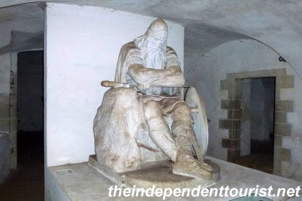 Statue of Holger the Dane underneath Kronborg Castle. The sleeping viking is to awaken and rescue Denmark in its hour of need.