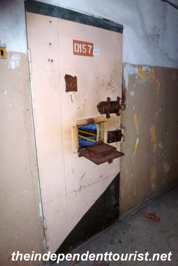 A cell door with a small opening for sliding food to the prisoner.