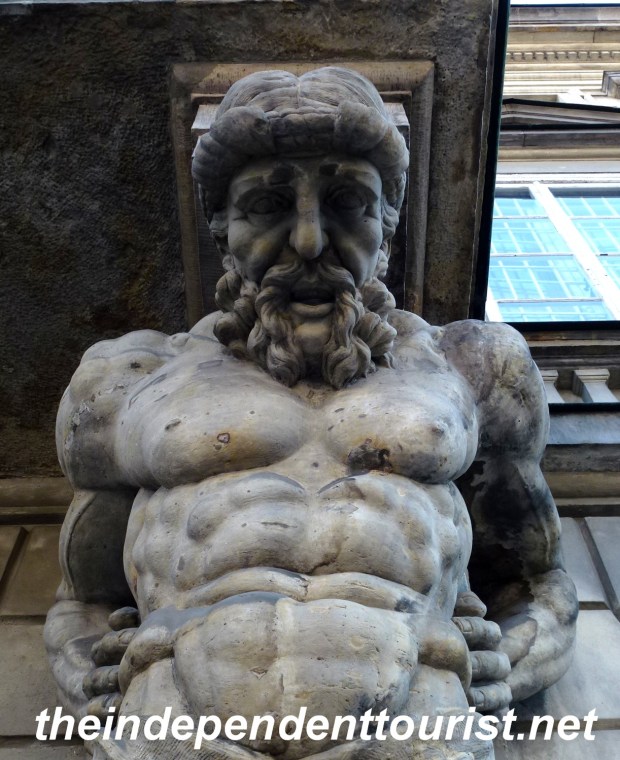 A decorative ledge support staring down on us in Warsaw Old Town.