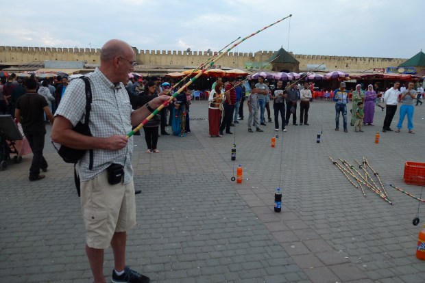 Paul trying to put a ring around the soda bottle neck. A lot harder than it looks! One of the many things to do in Place el Hedim.